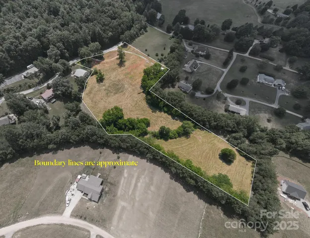 an aerial view of a house with a yard and lake view