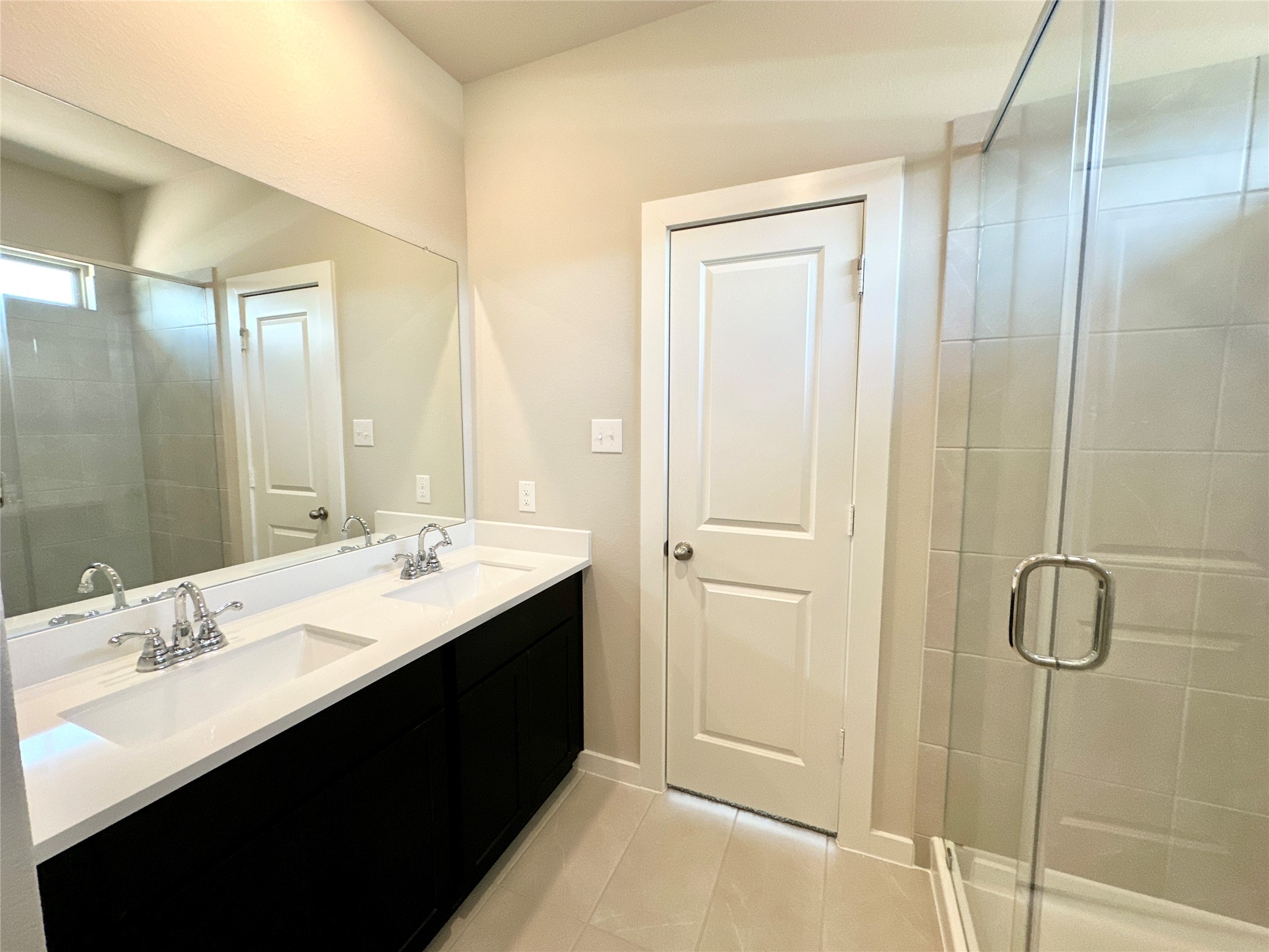 12164 Ridge Top Drive Conroe, TX 77304 - Photo 7 of 23 a bathroom with a double vanity sink a shower and a mirror