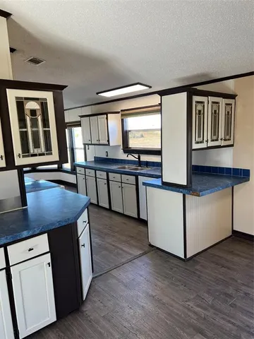 a view of kitchen with cabinets and wooden floor