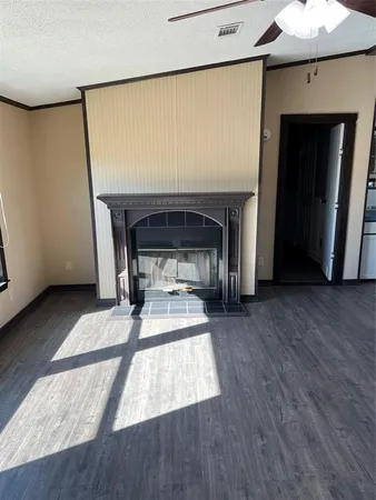 a living room with a fireplace furniture and a wooden floor