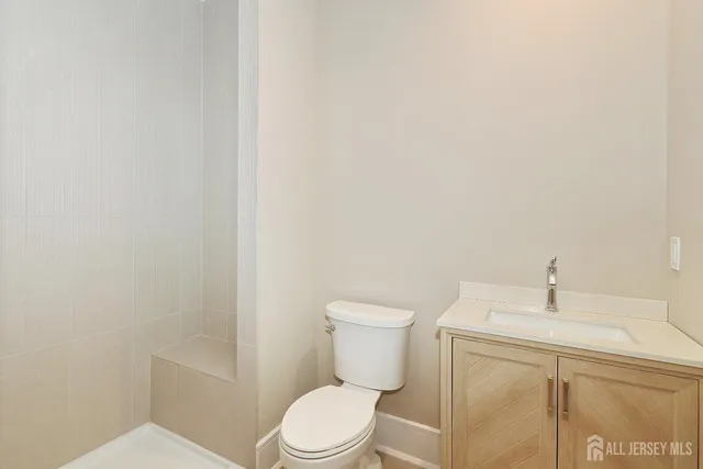 a white toilet sitting next to a bathroom sink