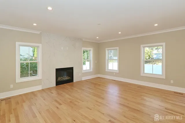 a view of an empty room with a window and a fireplace
