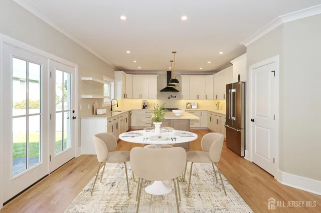 a large kitchen with a table and chairs