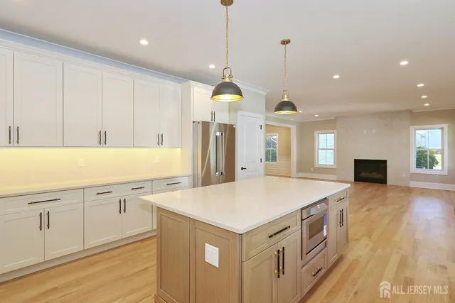 a kitchen that has a lot of cabinets and wooden floor