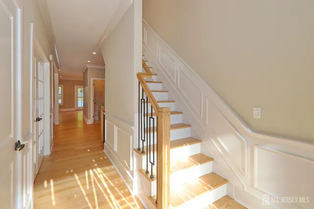 a view of a hallway with a white walls and stairs