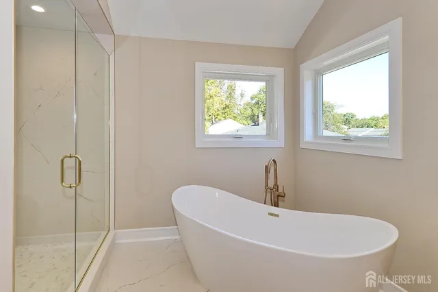 a white bath tub sitting next to a window
