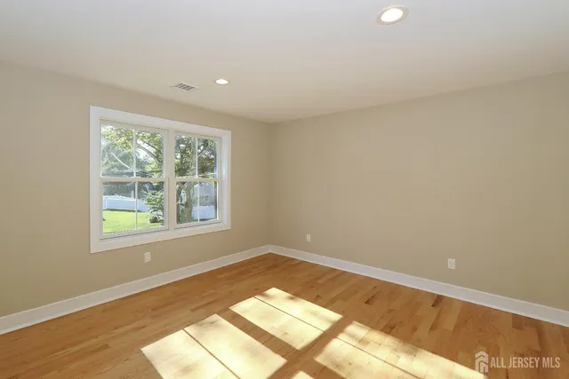 a view of an empty room and a window