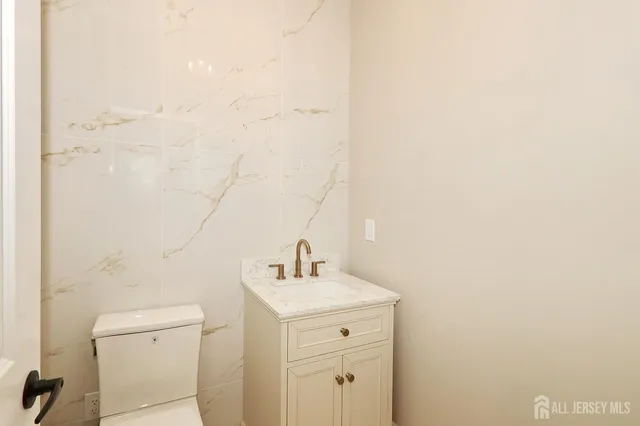 a bathroom with a sink a toilet and mirror