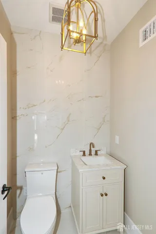 a bathroom with a sink mirror and toilet