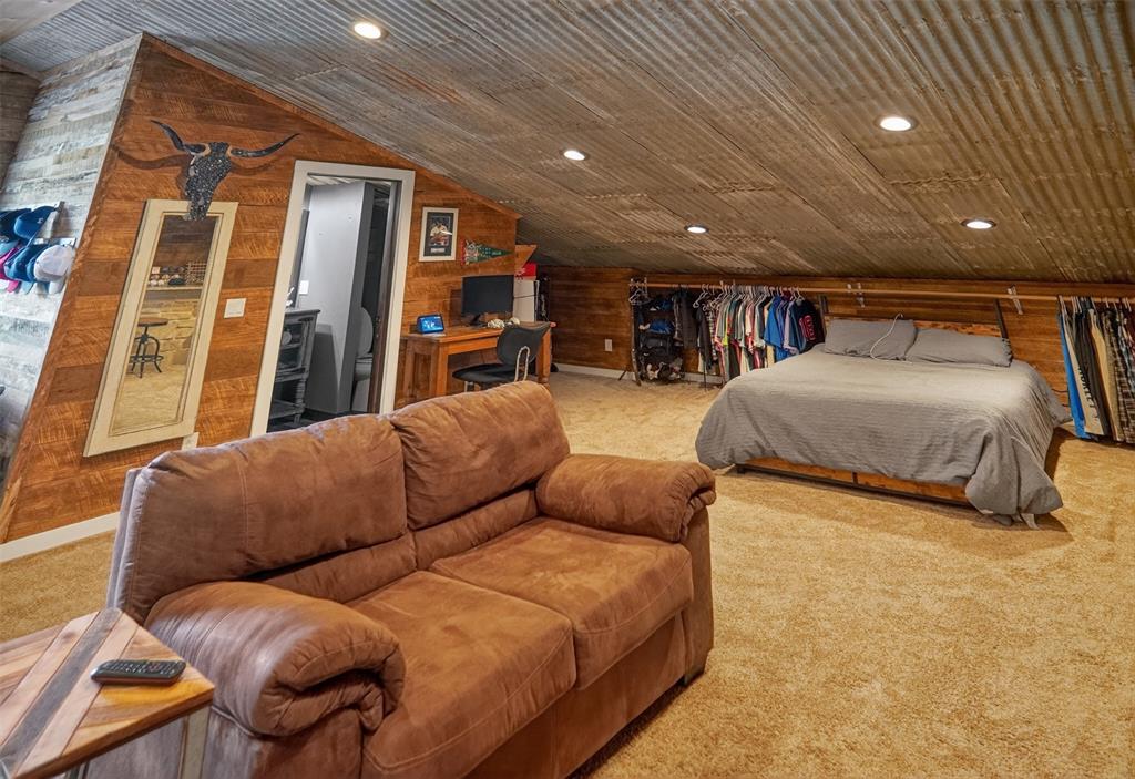 1524 County Road Sumner, TX 75486 - Photo 23 of 35 Spacious 2nd bedroom featuring corrugated metal ceiling, recessed lighting, wood-paneled accent wall, and carpet flooring