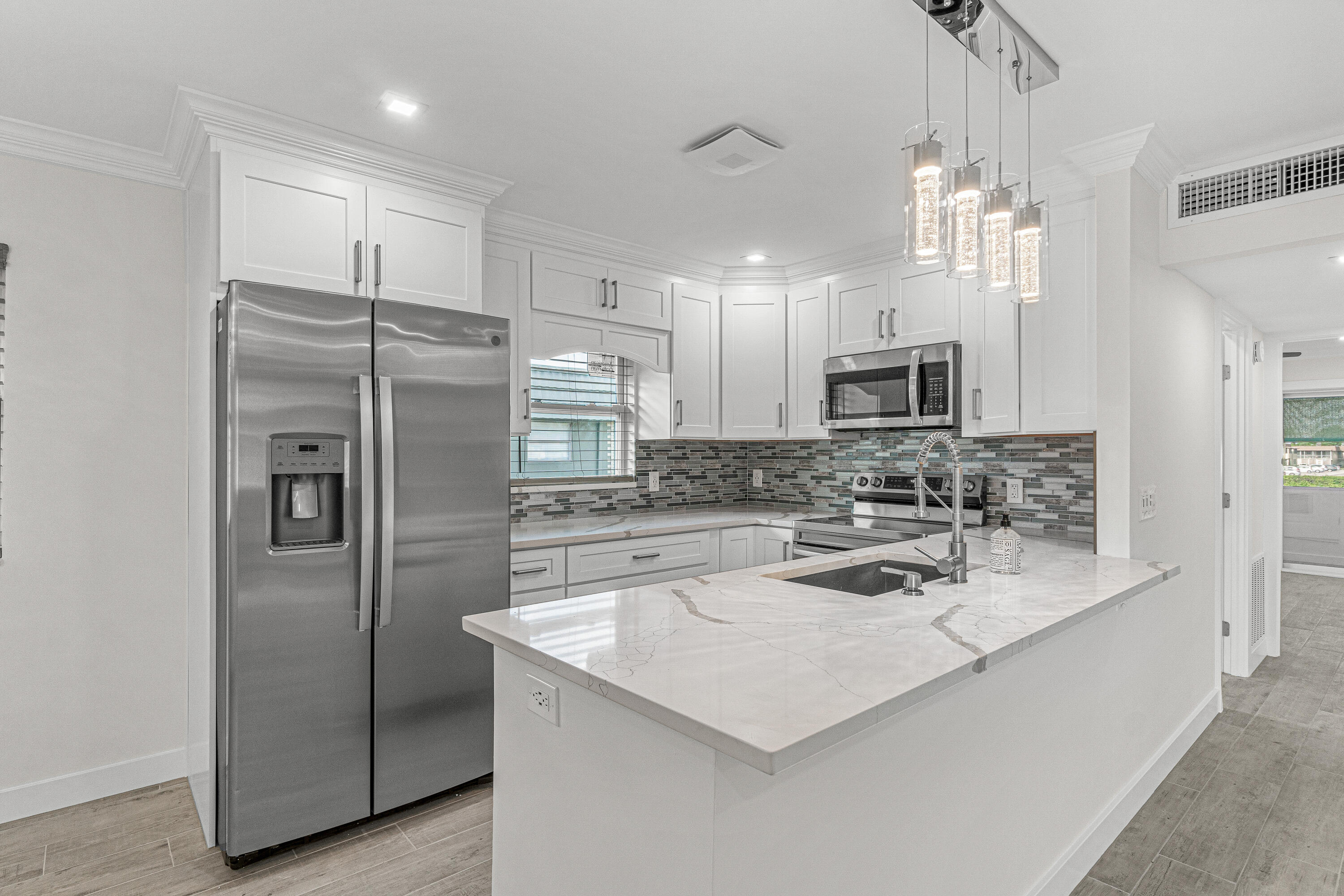 80 Flanders B Delray Beach, FL 33484 - Photo 1 of 26 a kitchen with a refrigerator a sink cabinets and a counter top space
