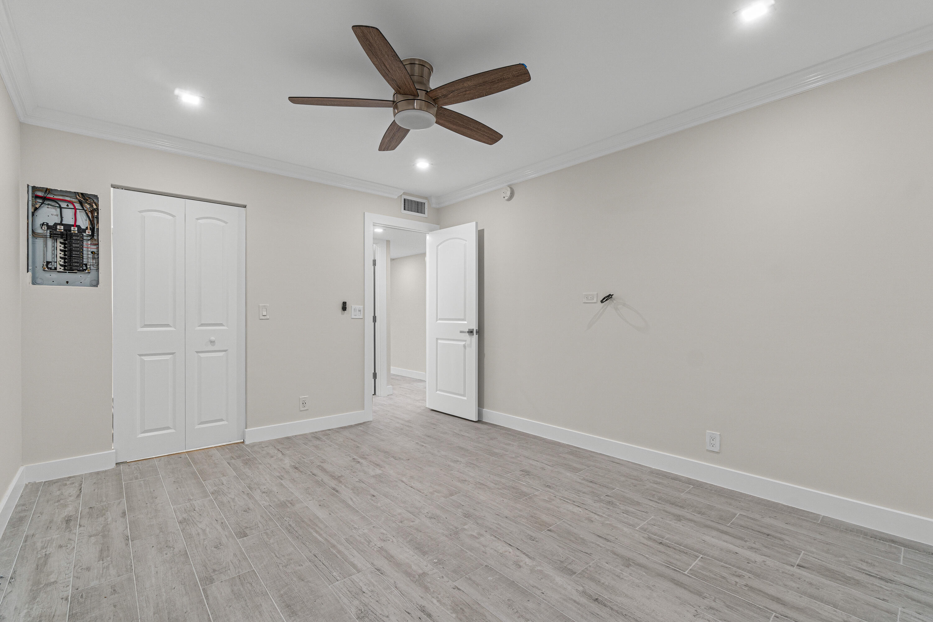 80 Flanders B Delray Beach, FL 33484 - Photo 13 of 26 an empty room with wooden floor and ceiling fan