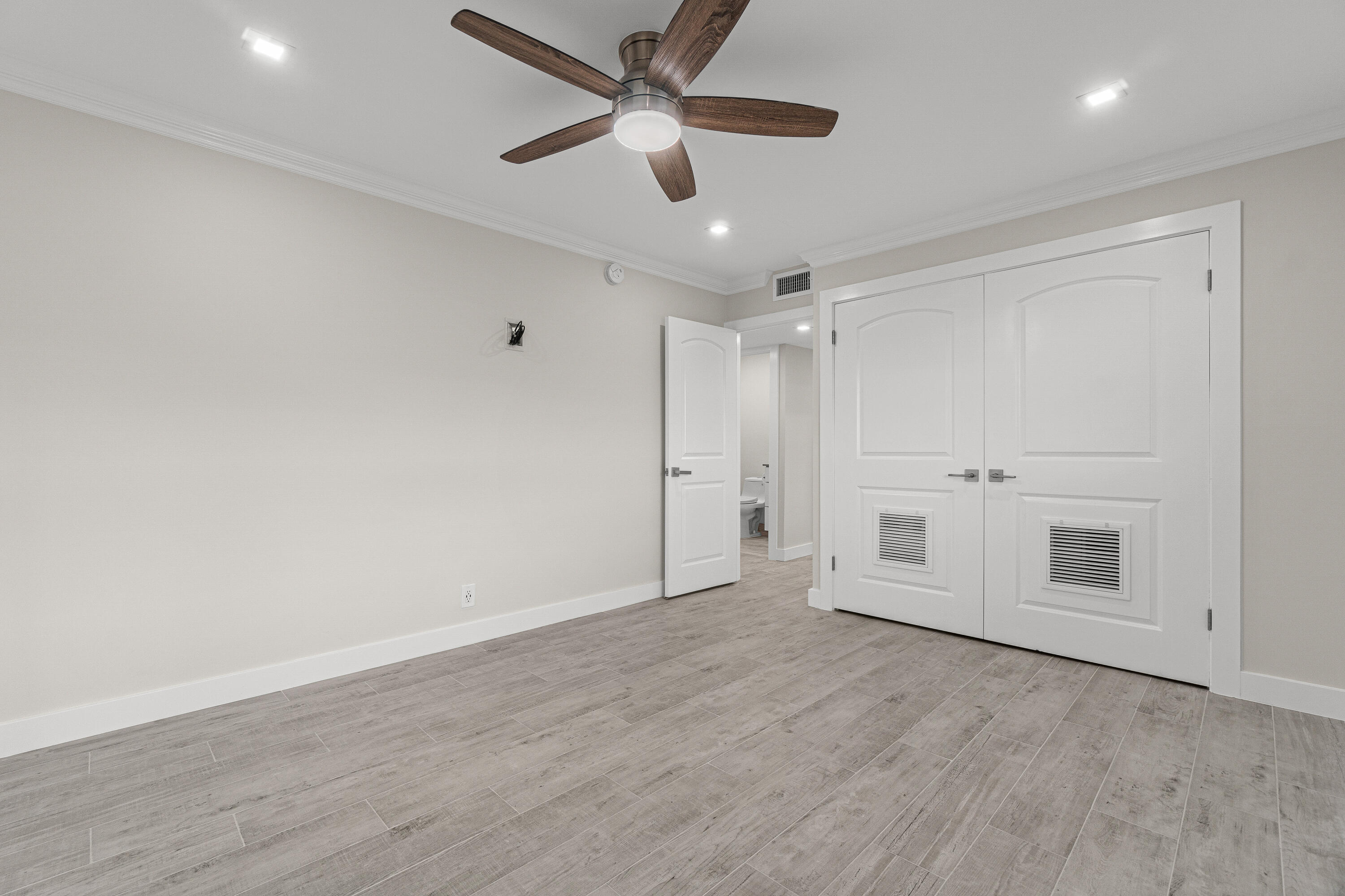 80 Flanders B Delray Beach, FL 33484 - Photo 15 of 26 a view of empty room with wooden floor and ceiling fan