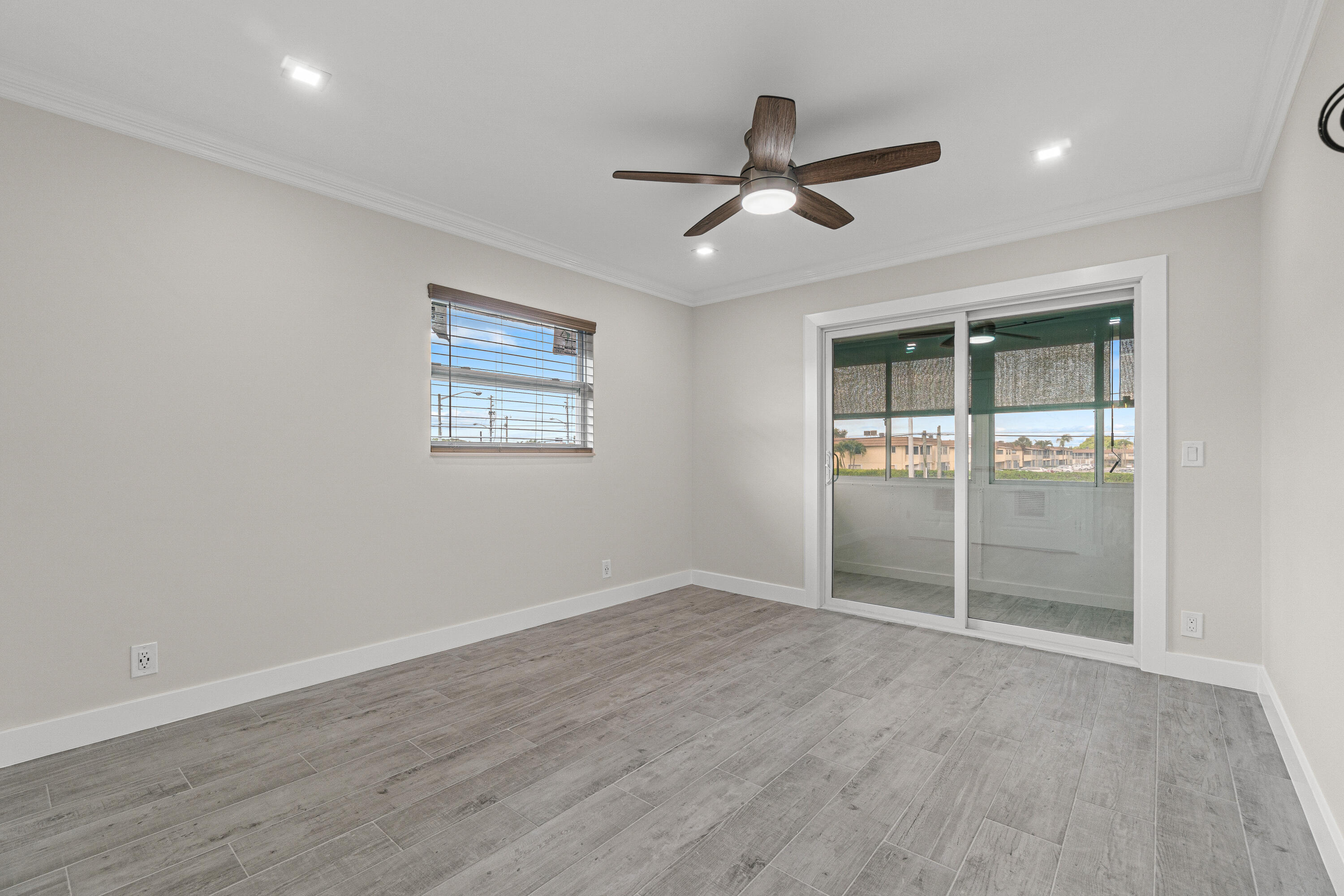 80 Flanders B Delray Beach, FL 33484 - Photo 17 of 26 a view of an empty room with wooden floor and a window