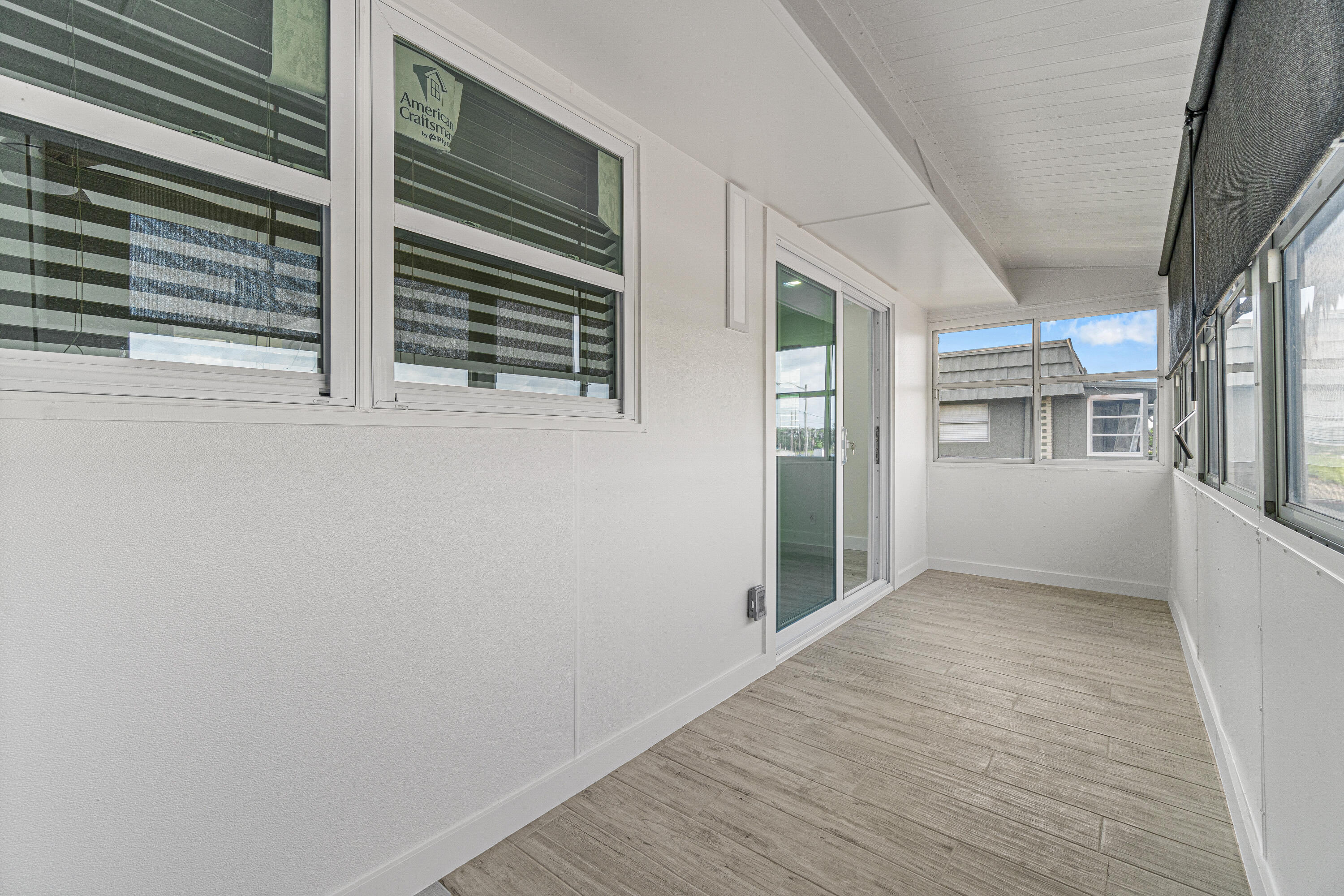 80 Flanders B Delray Beach, FL 33484 - Photo 21 of 26 a view of empty room with wooden floor and windows