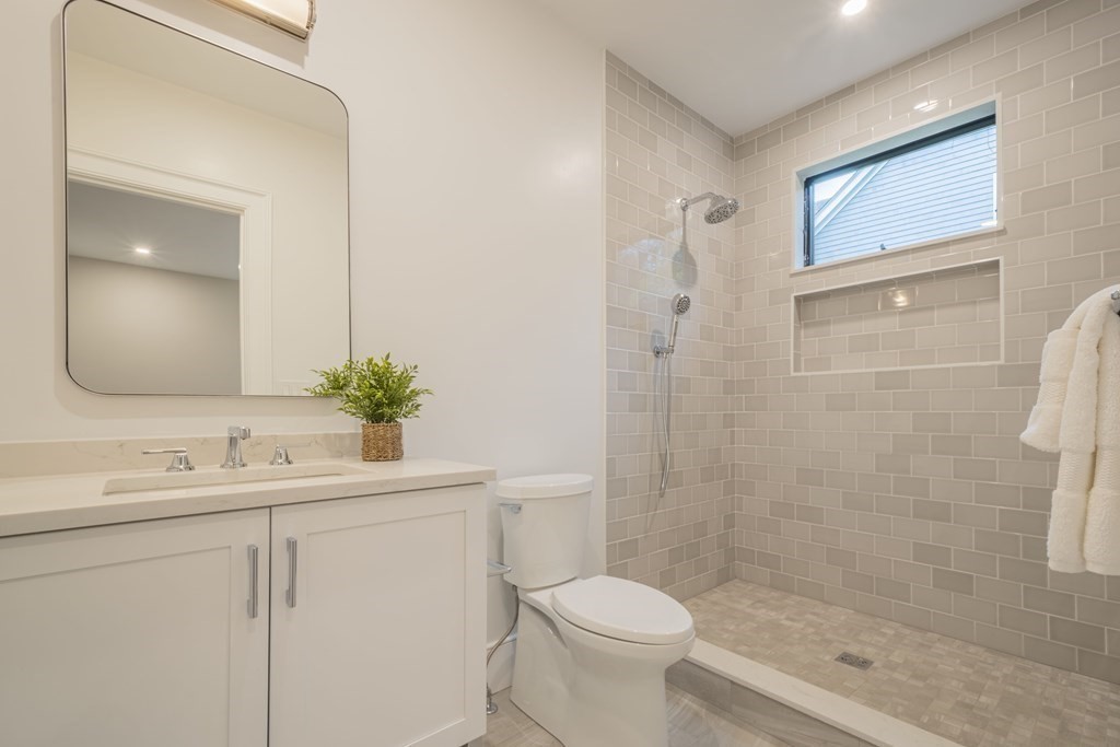 11 Sherburne Road Lexington, MA 02421 - Photo 20 of 42 a bathroom with a sink a toilet and shower
