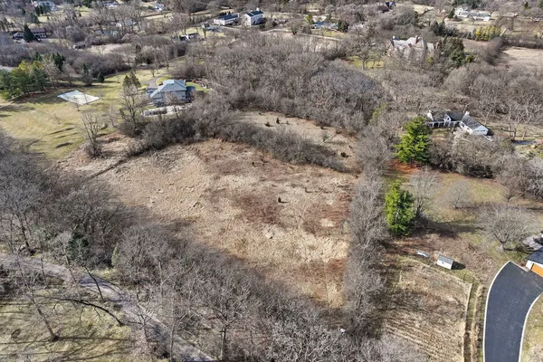 a view of a dry yard with lots of green space