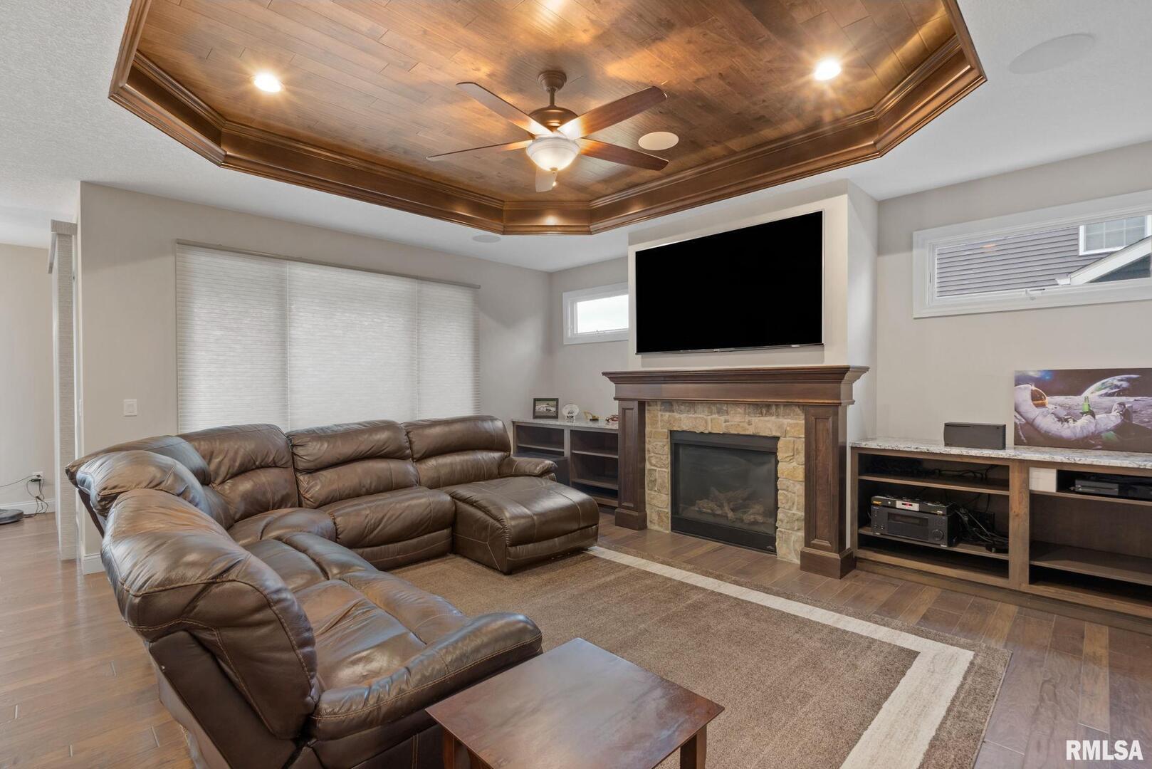 1422 Racine Court Davenport, IA 52804 - Photo 9 of 53 a living room with furniture a flat screen tv and a fireplace