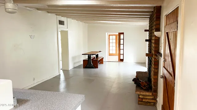 a view of a livingroom with furniture and a window