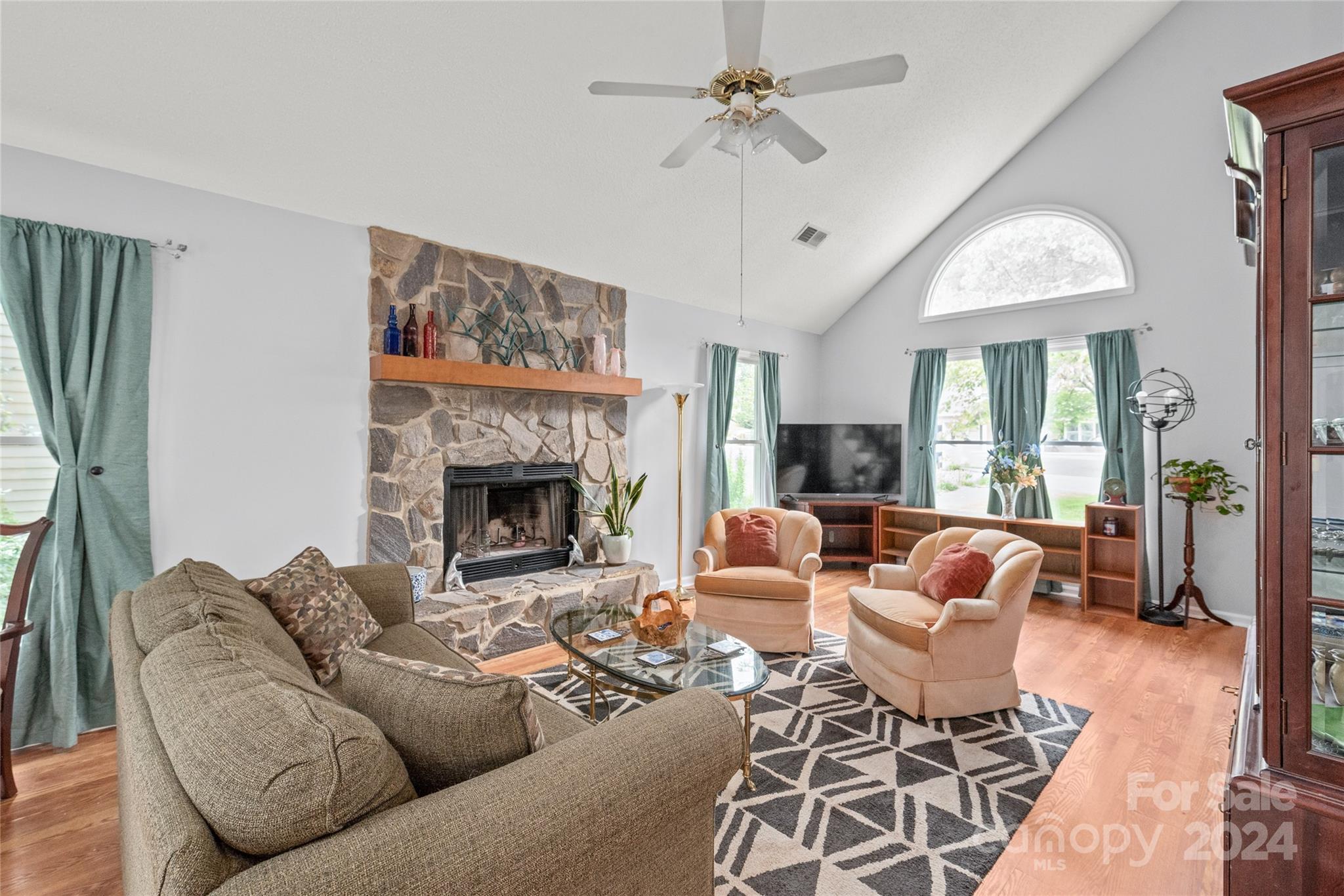 104 Banksridge Road Fort Mill, SC 29715 - Photo 9 of 45 a living room with furniture a fireplace and a flat screen tv