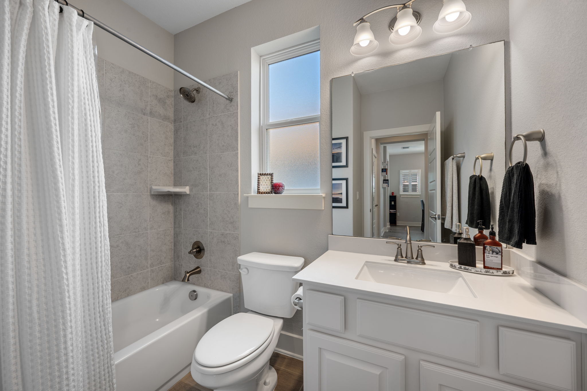 5409 Fox Wing Way Austin, TX 78747 - Photo 14 of 26 A well-appointed bathroom offers a clean vanity, bright lighting, and a window for natural light.