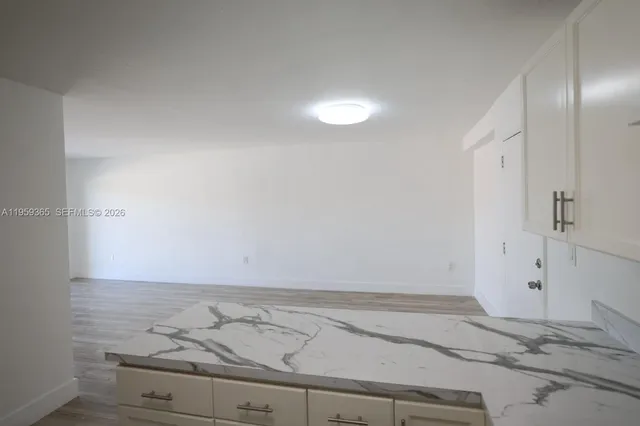 a view of room with wooden floor