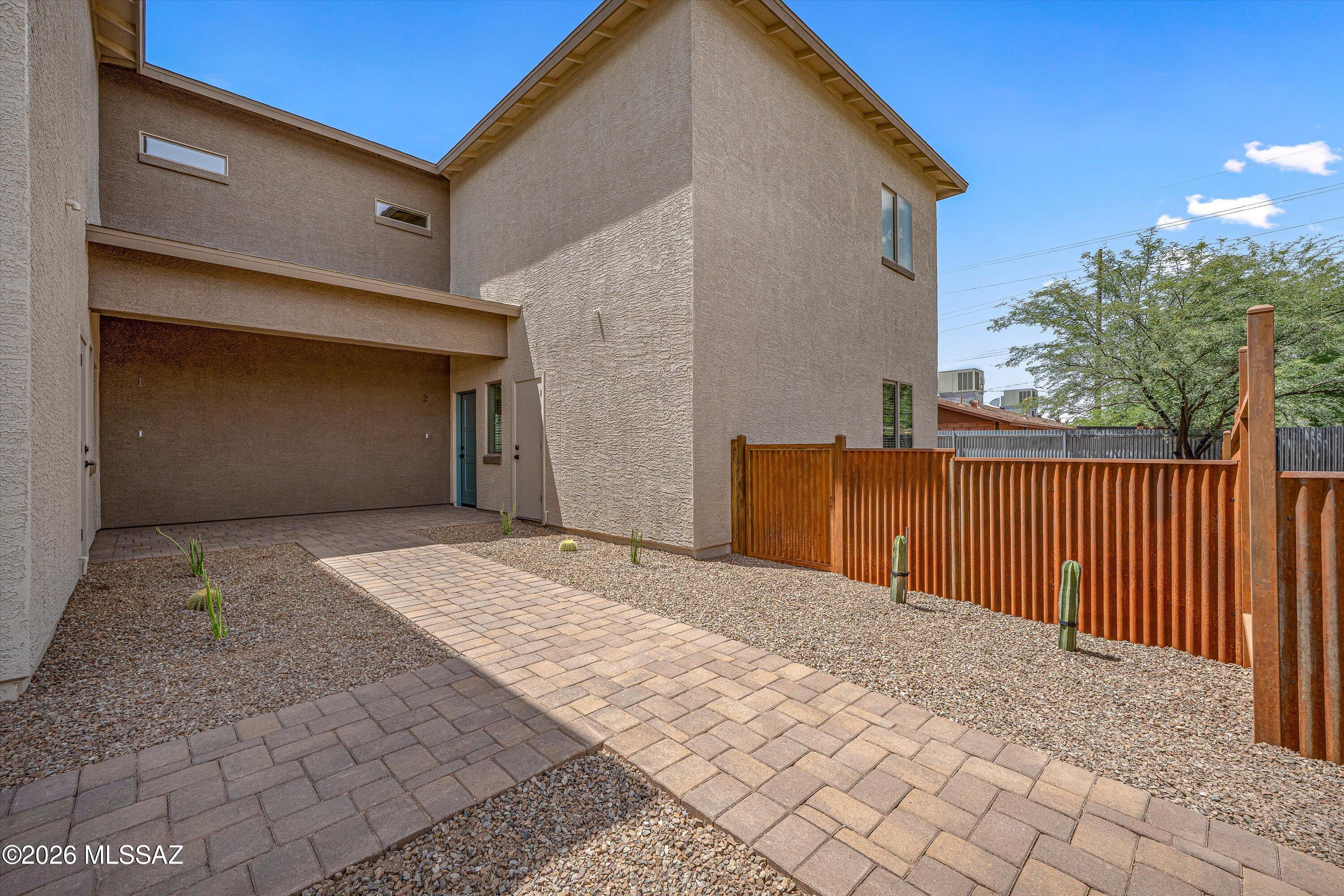 739 North Queen Avenue, Unit 2 Tucson, AZ 85705 - Photo 26 of 28 a view of backyard with large tree and wooden fence