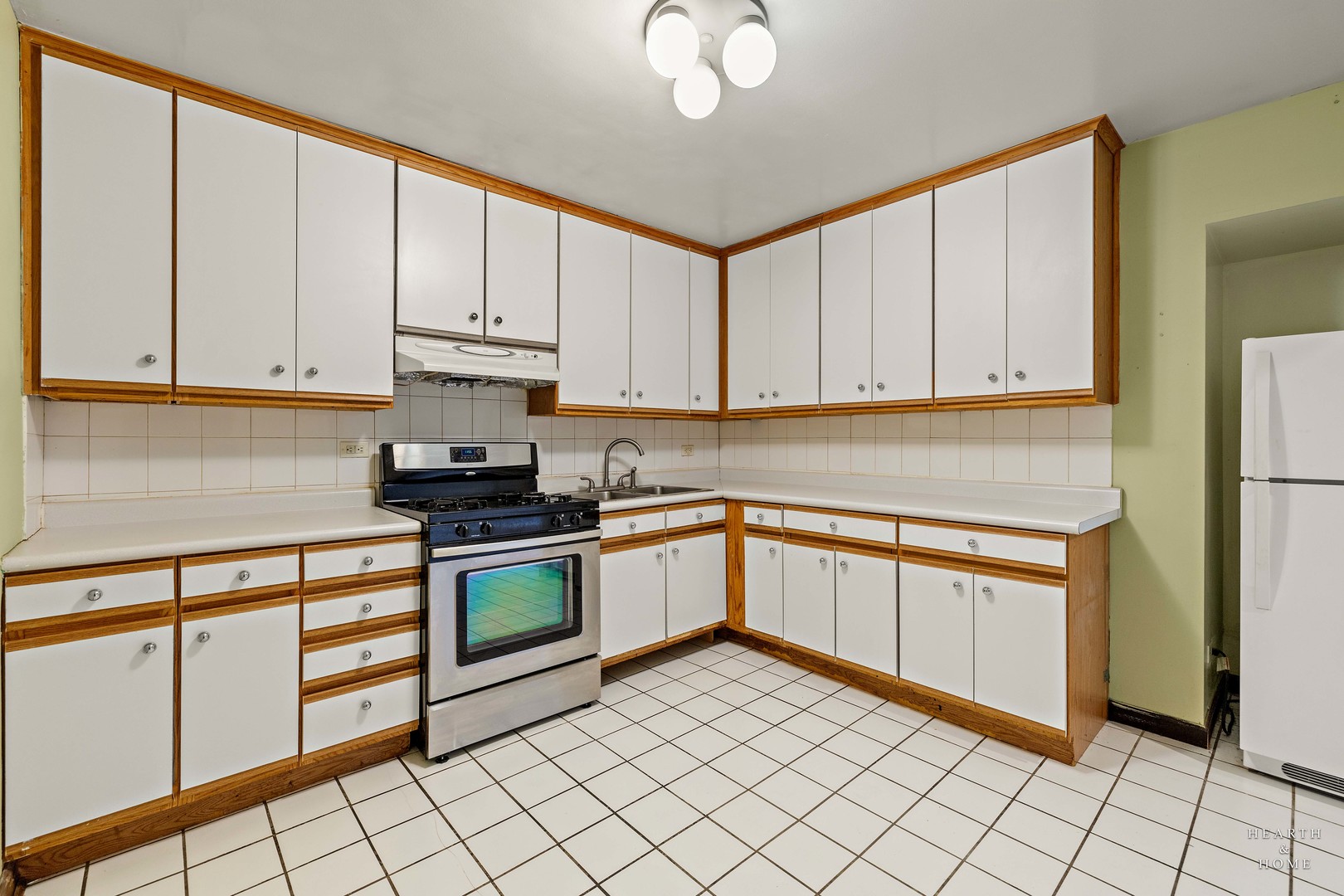 9500 Dee Road, Unit 2F Des Plaines, IL 60016 - Photo 7 of 20 a kitchen with granite countertop white cabinets and stainless steel appliances