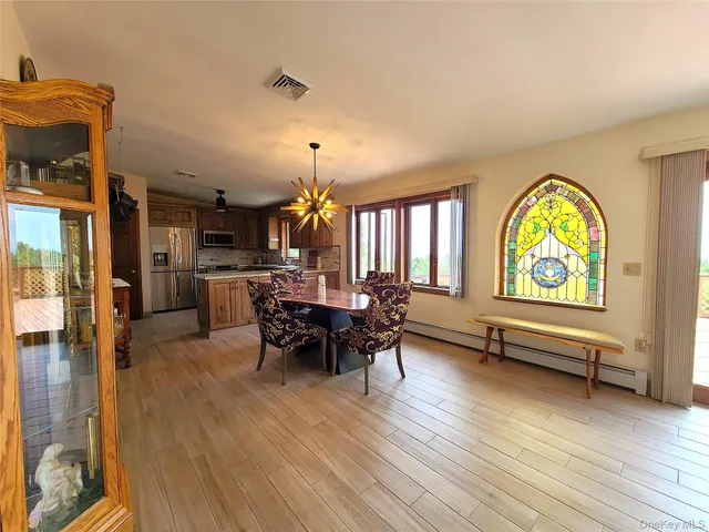 a large kitchen with a large window and stainless steel appliances