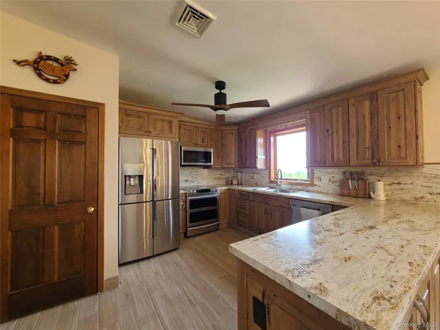 a spacious bathroom with a toilet sink and mirror