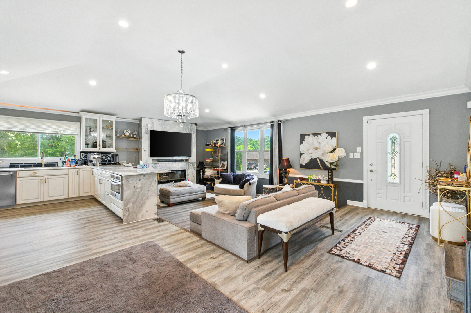 2938 East Shagbark Trail Crete, IL 60417 - Photo 4 of 26 a living room with furniture a flat screen tv and a chandelier