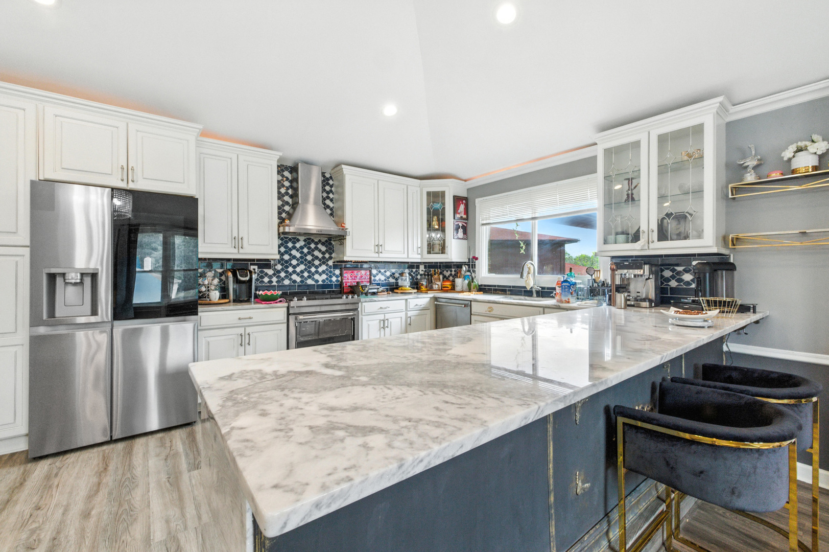 2938 East Shagbark Trail Crete, IL 60417 - Photo 7 of 26 a kitchen with stainless steel appliances granite countertop a stove top oven a sink a dining table and chairs