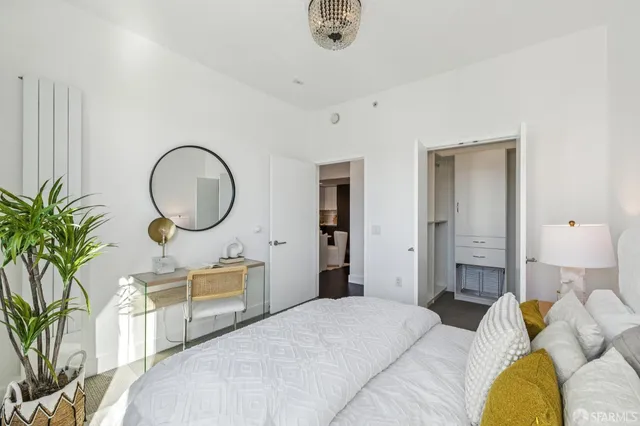a bedroom with bed and a chandelier