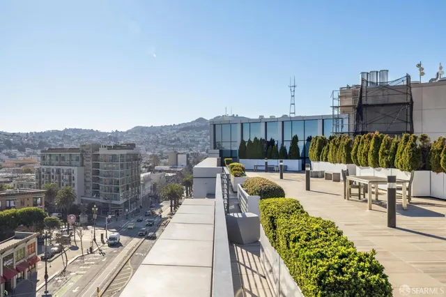a view of balcony with outdoor seating and city view