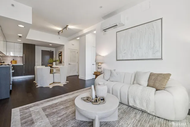 a living room with furniture and a dining table