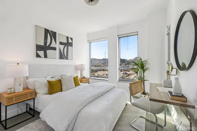 a bedroom with a bed a potted plant and a window