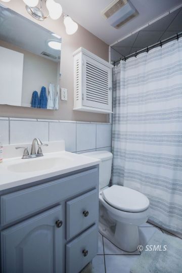 246 Peg Street Ridgecrest, CA 93555 - Photo 24 of 30 a bathroom with a granite countertop sink a toilet and a mirror