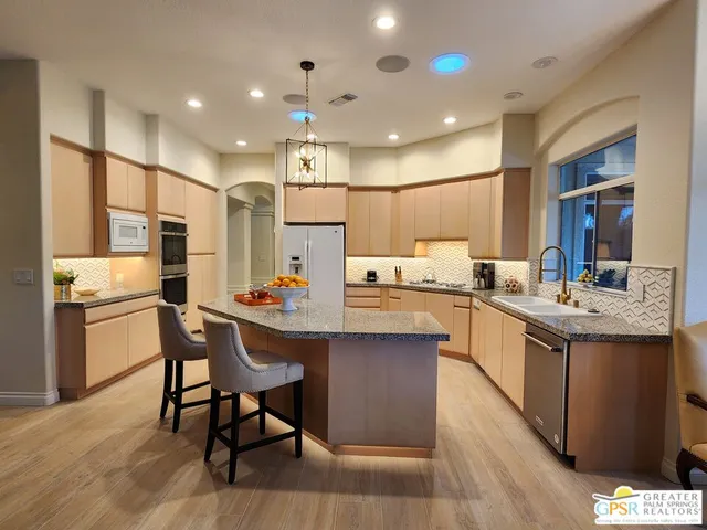 a stove top oven sitting inside of a kitchen