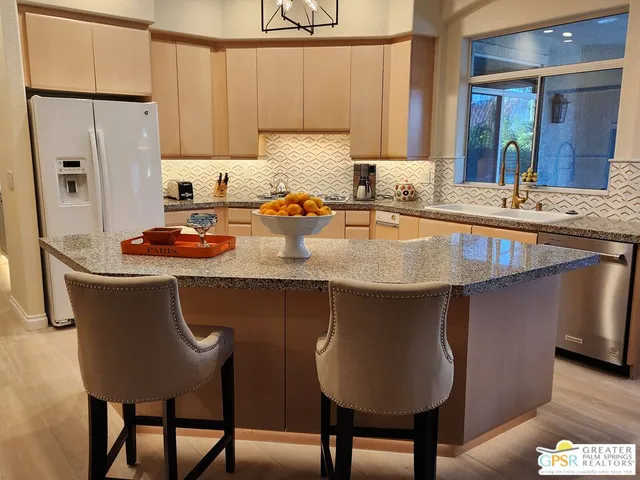 a view of a kitchen area kitchen island dining table and chairs