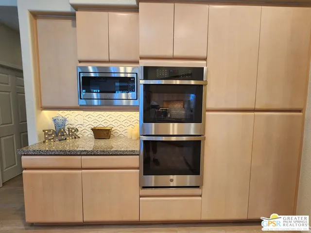 a room with a bed and a mirror on the dresser