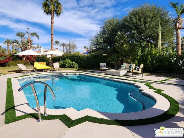 a view of a swimming pool with a lounge chairs