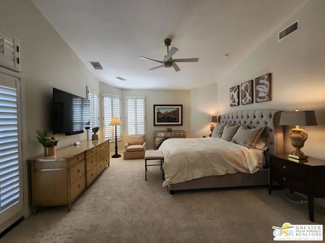 a bedroom with a bed and cupboard