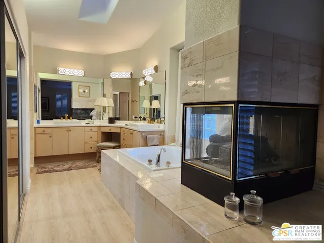 a bathroom with a double vanity sink and a mirror