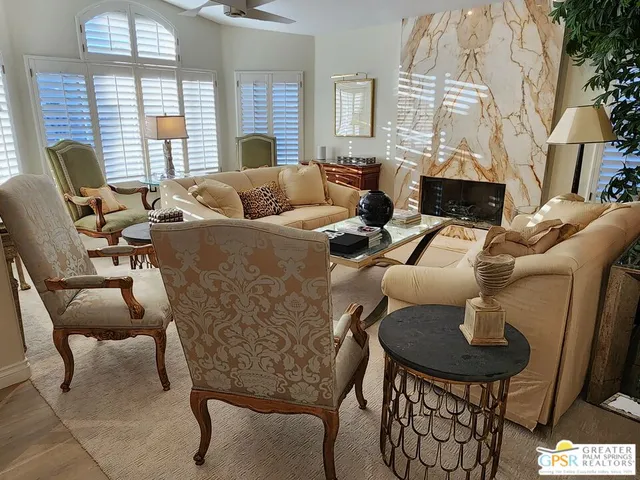 a dining room with furniture potted plants and wooden floor