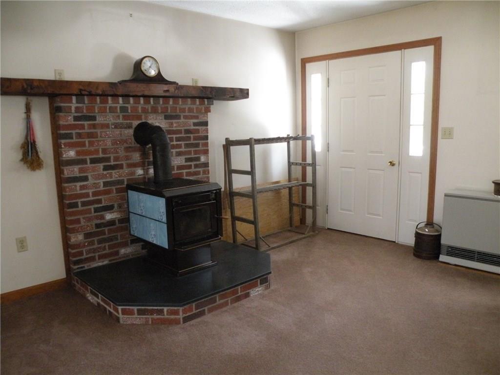 129 Castle Island Road Belgrade, ME 04917 - Photo 10 of 29 FRONT ENTRY DOOR AND HEARTH WITH...