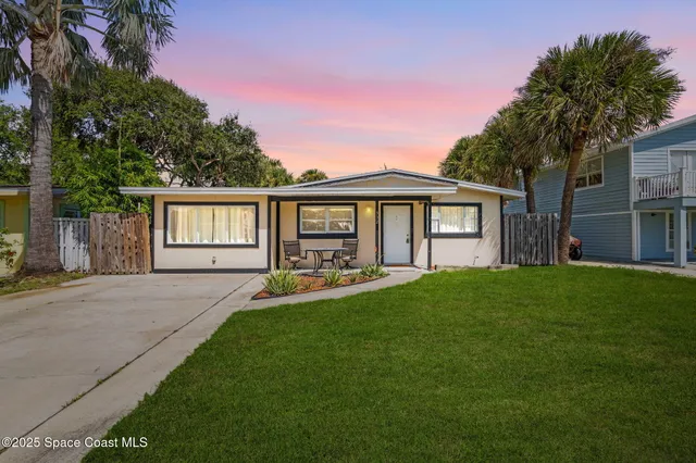 a front view of a house with yard patio and green space
