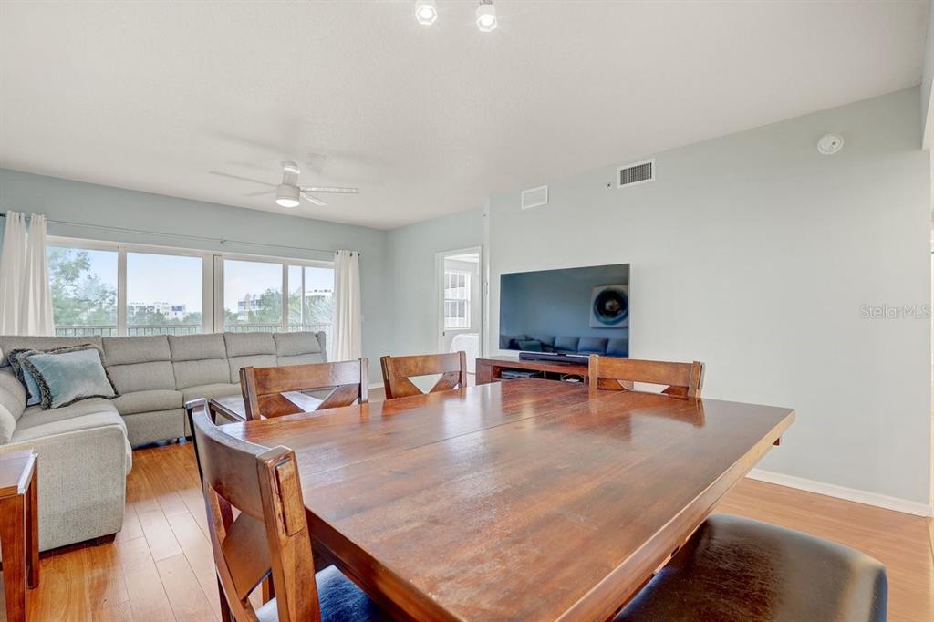960 Starkey Road, Unit 2405 Largo, FL 33771 - Photo 11 of 31 a dining room with furniture and wooden floor