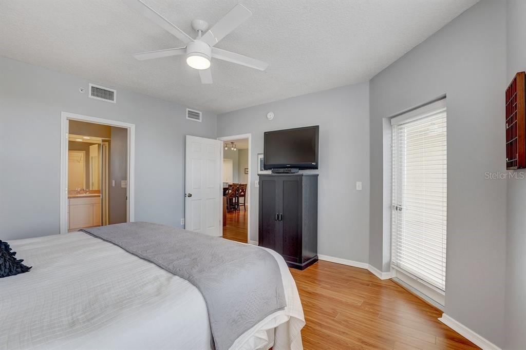 960 Starkey Road, Unit 2405 Largo, FL 33771 - Photo 18 of 31 a bedroom with a bed and a flat screen tv