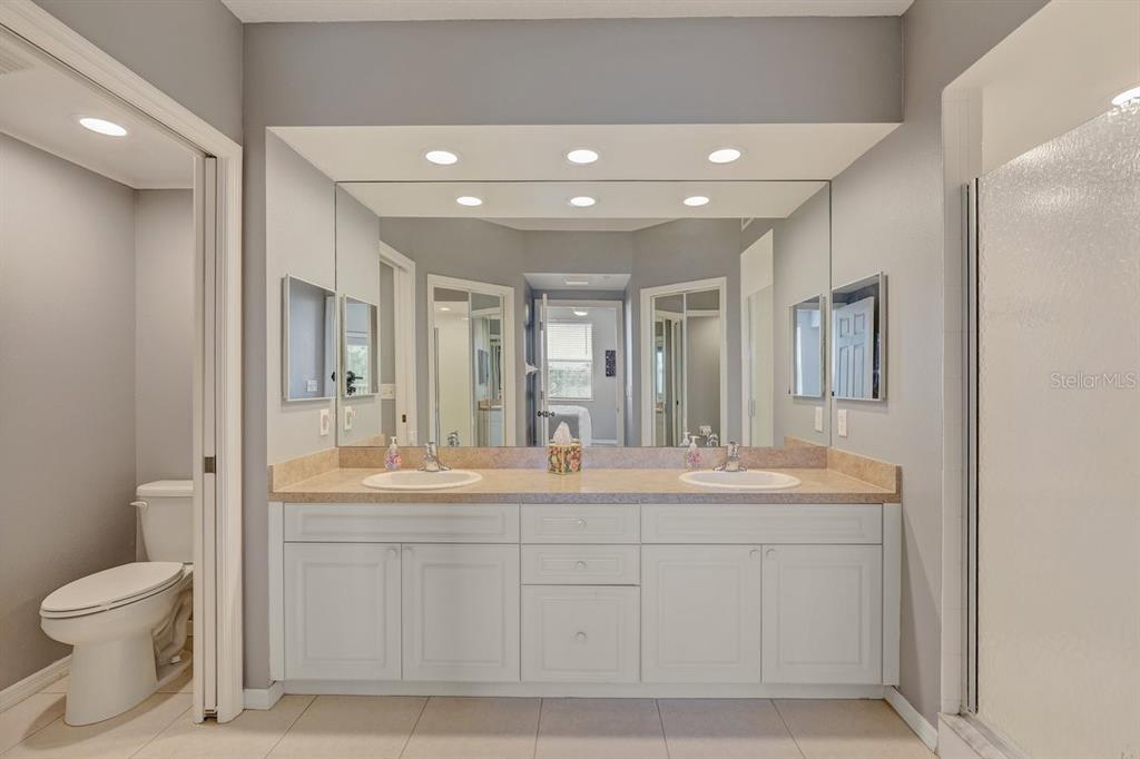 960 Starkey Road, Unit 2405 Largo, FL 33771 - Photo 21 of 31 a spacious bathroom with a double vanity sink toilet mirror and double