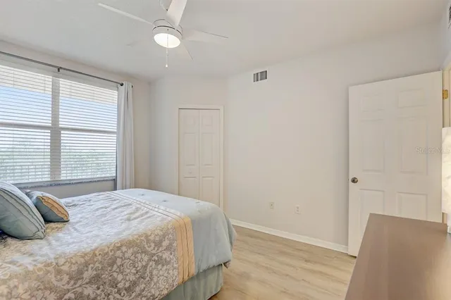a bedroom with a bed and wooden floor